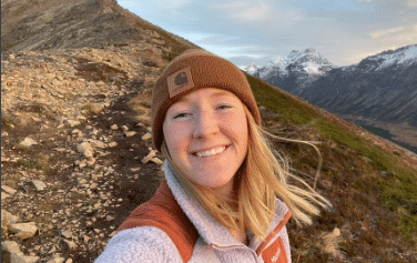 Your guide, Tasha out adventuring in the mountains!